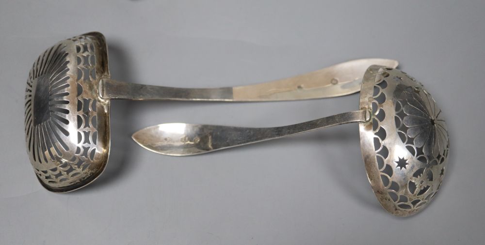 Two Dutch white metal sifter spoons, a Chinese white metal vase (base missing0 and two toy items, Dutch & Chinese.